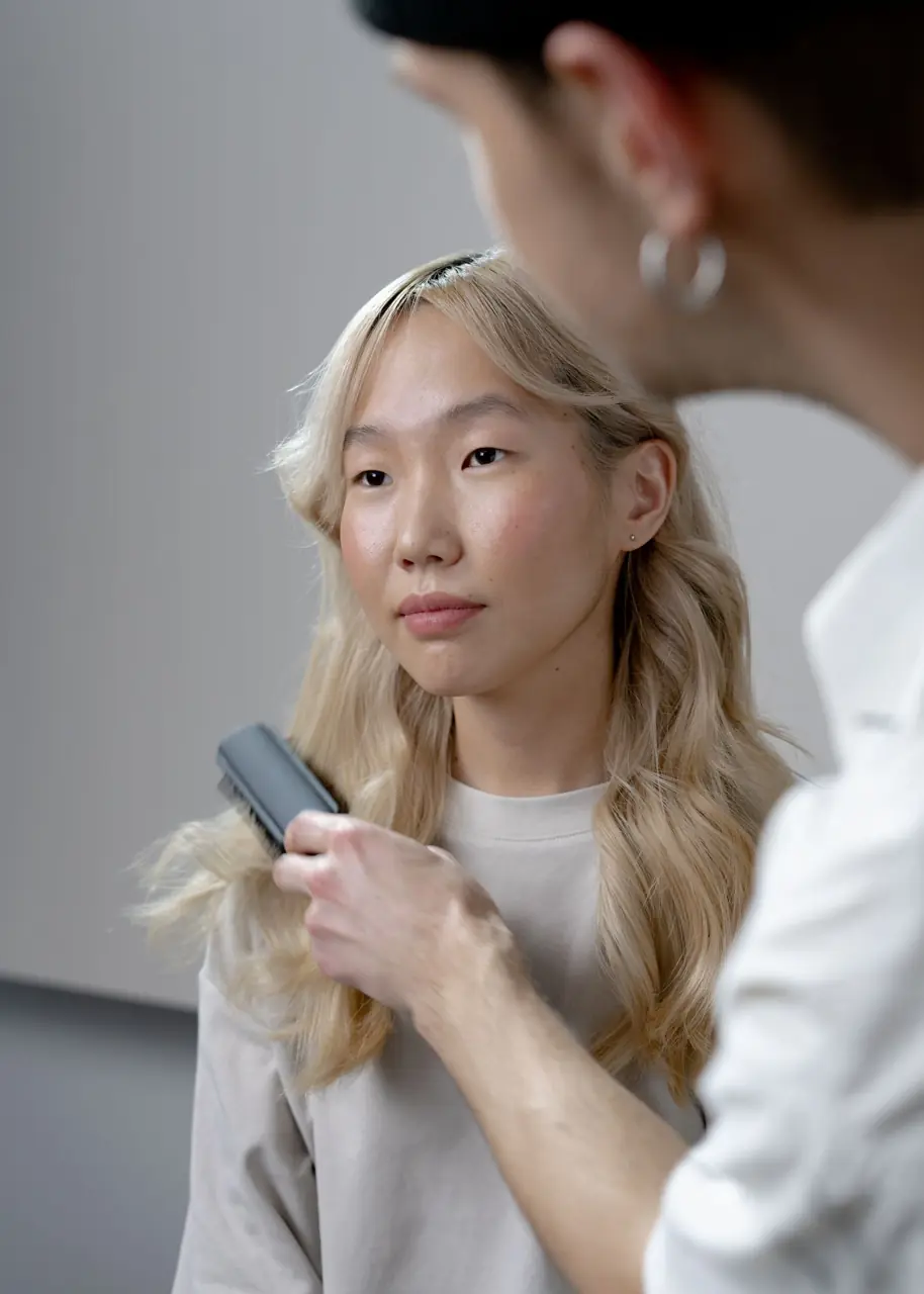 Stylist styling a client's hair